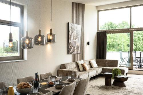 a living room with a couch and a table at Kooparc vakantiepark in Giesbeek