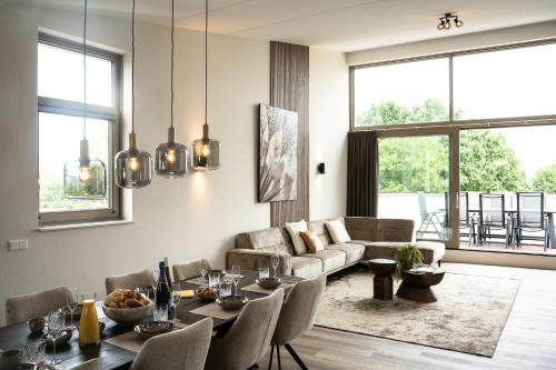 a living room with a table and a couch at Kooparc vakantiepark in Giesbeek