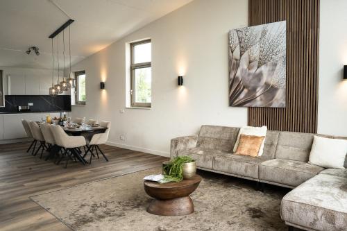 a living room with a couch and a table at Kooparc vakantiepark in Giesbeek