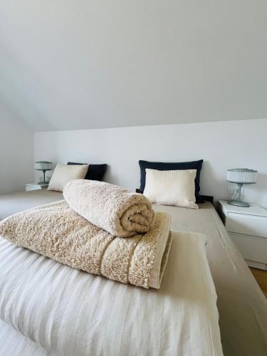 a bedroom with a bed with two pillows on it at Apartma DUDI 