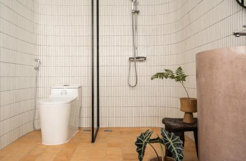 a bathroom with a shower and a toilet at A Stay In Hanoi in Hanoi