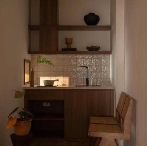 a kitchen with a sink and a chair at A Stay In Hanoi in Hanoi