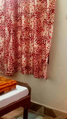 a curtain hanging on a wall in a room at The Misty Hotel in Bhatwāri