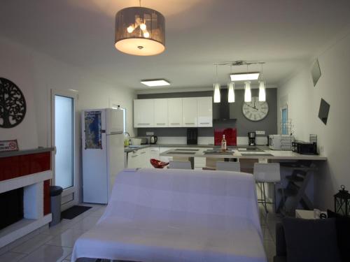 a kitchen with white cabinets and a white refrigerator at AMETLLERS - Apartamento renovado y totalmente equipado, situado en un tercero sin ascensor en la zona de la Vila - ES-228-193 in Llança