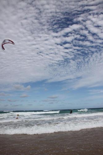 a person is flying a kite in the ocean at Linga Bay Retreat in Morrumbene