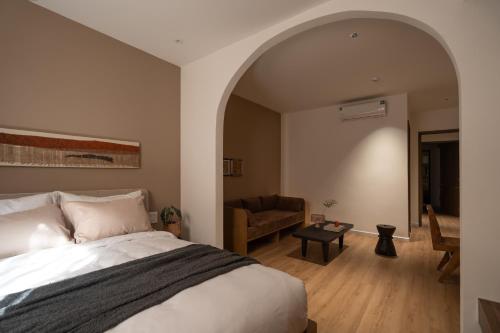 a bedroom with a bed and a living room at A Stay In Hanoi in Hanoi