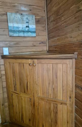 a wooden cabin with a wooden wall at Linga Bay Retreat in Morrumbene