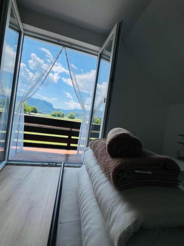 a room with a couch and a large window at Apartma DUDI 