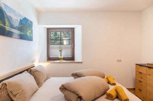 a bedroom with two pillows on a bed with a window at Apart Celina in Oetz