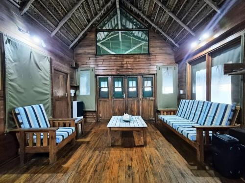 a living room with two couches and a table at Linga Bay Retreat in Morrumbene