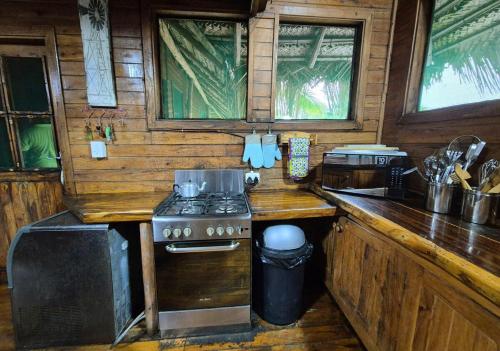 a kitchen with a stove and a counter top at Linga Bay Retreat in Morrumbene