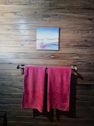 two pink towels hanging on a rack in a room at Linga Bay Retreat in Morrumbene