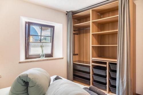 a room with a window and a closet with shelves at Apart Celina in Oetz