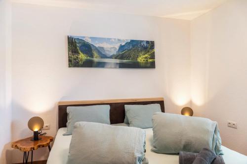 a bedroom with a bed with a picture on the wall at Apart Celina in Oetz
