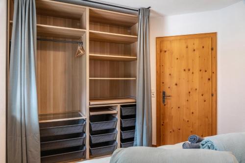 a closet with wooden shelves and a door at Apart Celina in Oetz