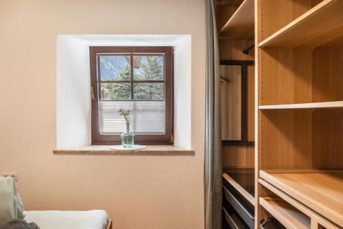 a window in a closet with a vase on a shelf at Apart Celina in Oetz