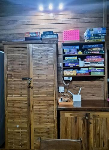 a room with a desk with a book shelf filled with books at Linga Bay Retreat in Morrumbene