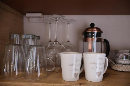 a group of glass bottles and cups on a counter at Aalkie's Dream in Swellendam