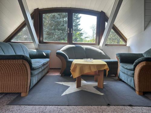 a living room with two couches and a table at Ferienhaus Gisela in Fürstenberg-Havel