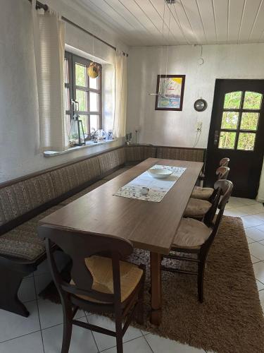 a dining room with a wooden table and chairs at Ferienhaus Gisela in Fürstenberg-Havel