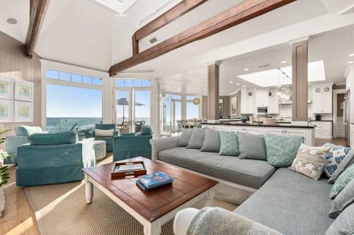 a living room with a couch and a table at Malibu Dunes by Fieldtrip Expansive Hamptons-Style Estate w Private Beach Backyard in Malibu