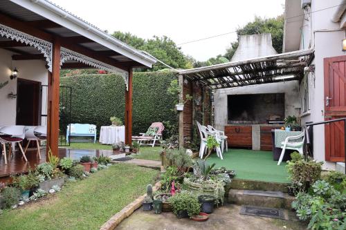 a garden with a pergola and a table and chairs at Aalkie's Dream in Swellendam