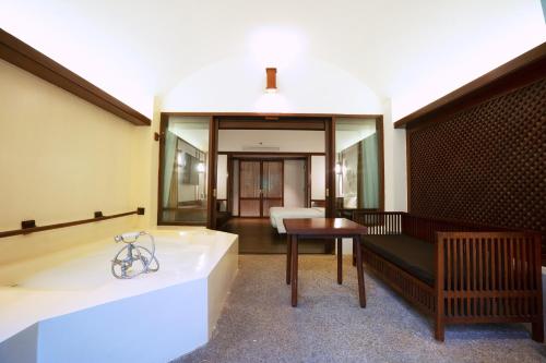 a living room with a couch and a table at Novotel Bogor Golf Resort in Bogor