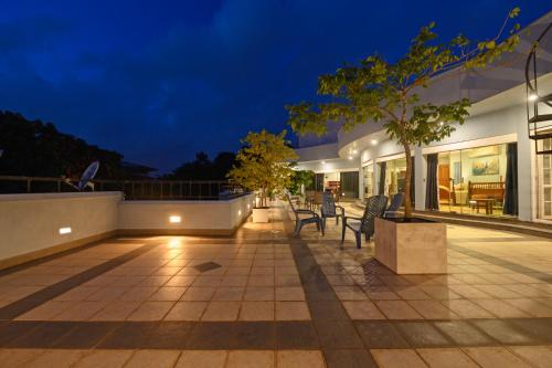 an outdoor patio with chairs and tables at night at Villa 53 in Battaramulla
