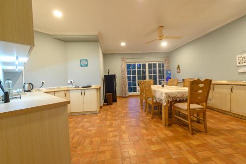 a kitchen and dining room with a table and chairs at Villa 53 in Battaramulla
