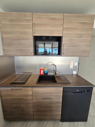 a kitchen with a sink and a sink at 2Cap d'Agde NATURISTE Grand T2 de standing avec GARAGE privé in Cap d'Agde