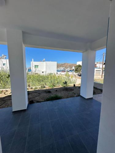 an empty room with a view of a building at #7 Lipsi Port Apartment Sea Views-Ground floor-No#7 in Lipsoi