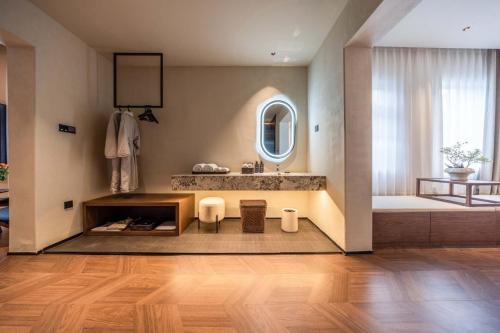 a bathroom with a sink and a mirror at Yi Nian · Fangcun Hotel in Nanchang