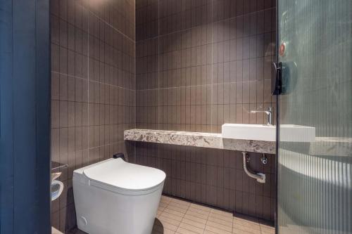 a bathroom with a toilet and a sink at Yi Nian · Fangcun Hotel in Nanchang