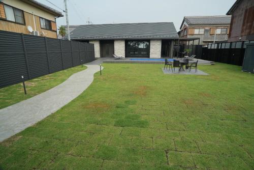 a yard with a table and chairs in it at LAKE villa CHITOSE in Hikone