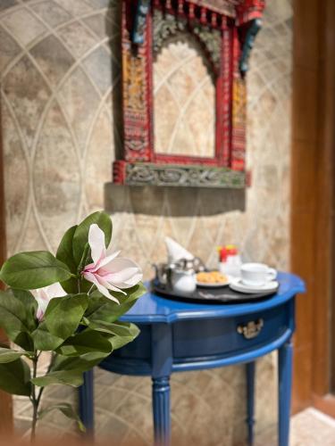 a blue table with a plate of food on it at Vaydantaa - Luxury Boutique Resort Mussoorie in Mussoorie