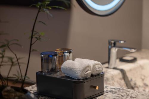 a pile of towels sitting on top of a bathroom counter at Yi Nian · Fangcun Hotel in Nanchang