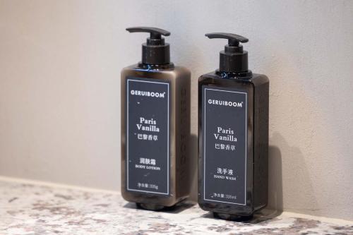 two bottles of soap are sitting on a counter at Yi Nian · Fangcun Hotel in Nanchang