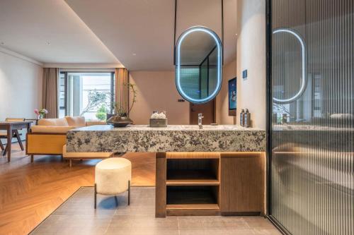 a bathroom with a sink and a mirror at Yi Nian · Fangcun Hotel in Nanchang