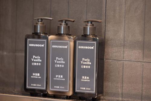 a group of three bottles sitting on a shelf at Yi Nian · Fangcun Hotel in Nanchang