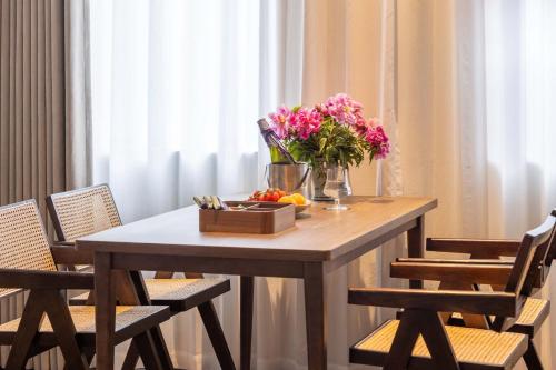a table with a bowl of fruit and flowers on it at Yi Nian · Fangcun Hotel in Nanchang