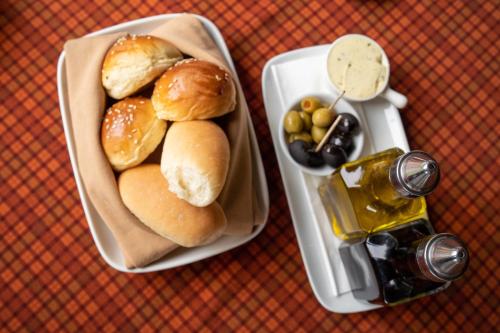 a tray of bread and olives and a bottle of beer at Novotel Bogor Golf Resort in Bogor