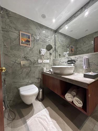a bathroom with a sink and a toilet in it at Vaydantaa - Luxury Boutique Resort Mussoorie in Mussoorie