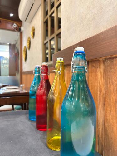 four different colored bottles sitting on a table at Vaydantaa - Luxury Boutique Resort Mussoorie in Mussoorie