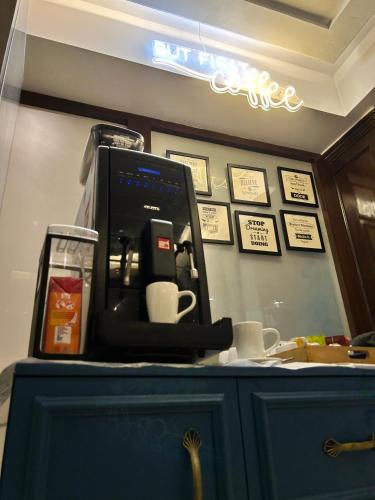 a coffee machine sitting on top of a counter with cups at Vaydantaa - Luxury Boutique Resort Mussoorie in Mussoorie