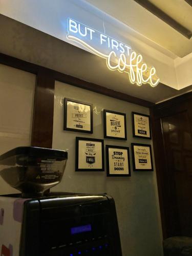 a sign that says first coffee on a wall at Vaydantaa - Luxury Boutique Resort Mussoorie in Mussoorie