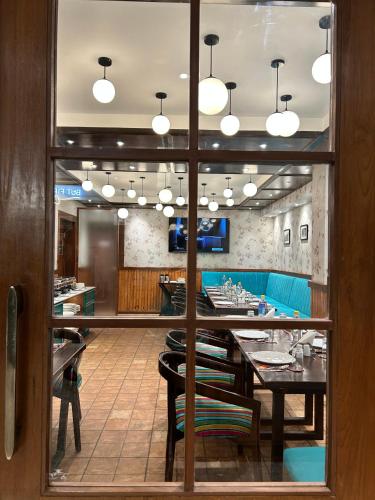 a dining room with a long table and chairs at Vaydantaa - Luxury Boutique Resort Mussoorie in Mussoorie