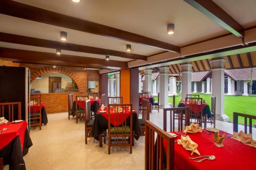 a restaurant with red table cloths on tables at Novotel Bogor Golf Resort in Bogor
