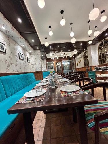 a dining room with a long wooden table and chairs at Vaydantaa - Luxury Boutique Resort Mussoorie in Mussoorie