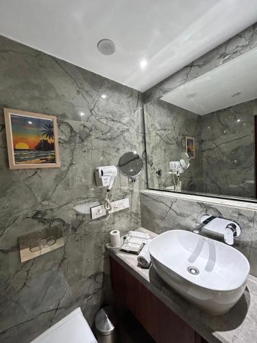 a bathroom with a sink and a mirror at Vaydantaa - Luxury Boutique Resort Mussoorie in Mussoorie
