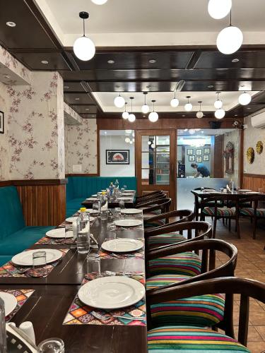 a dining room with a long table and chairs at Vaydantaa - Luxury Boutique Resort Mussoorie in Mussoorie